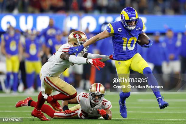 Cooper Kupp of the Los Angeles Rams runs after a catch in the fourth quarter against Jaquiski Tartt and K'Waun Williams of the San Francisco 49ers in...