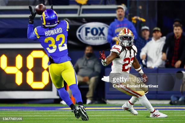 Travin Howard of the Los Angeles Rams intercepts a pass late in the fourth quarter intended for JaMycal Hasty of the San Francisco 49ers in the NFC...