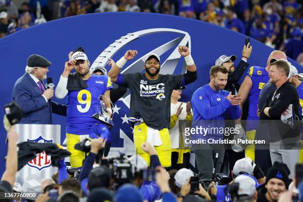 Matthew Stafford, Aaron Donald and head coach Sean McVay of the Los Angeles Rams react with the George Halas Trophy after defeating the San Francisco...