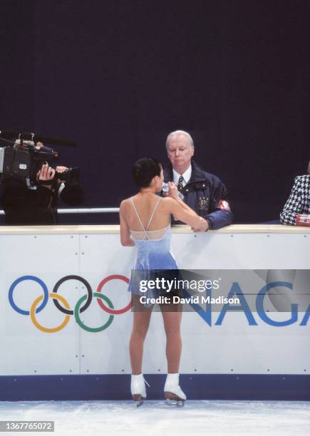 Michelle Kwan of the USA and her coach Frank Carroll confer before the start of her free program in the Ladies Singles event of the figure skating...