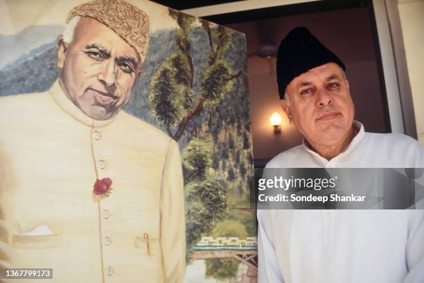 National Conference party leader Dr Farooq Abdullah stand for a photo with a painting of his father Sheikh Abdullah in New Delhi, March 01, 1995.