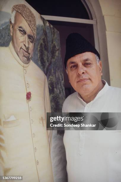 National Conference party leader Dr Farooq Abdullah stands for a photo with a painting of his father Sheikh Abdullah in New Delhi, March 01, 1995.