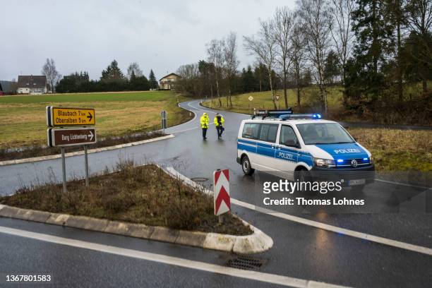 Police vehicle blocks the road leading to the scene of a shooting that left two police officers dead in Ulmet on January 31, 2022 near Kusel,...