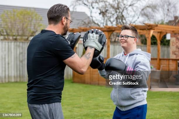 father and son training together - down syndrome bildbanksfoton och bilder