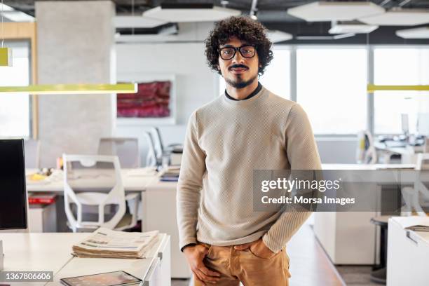 portrait of smiling businessman standing in office - män i 30 årsåldern bildbanksfoton och bilder