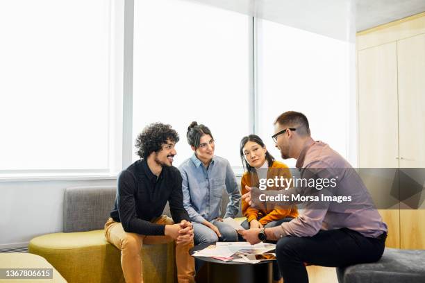 business professionals discussing in office - connect 4 stockfoto's en -beelden