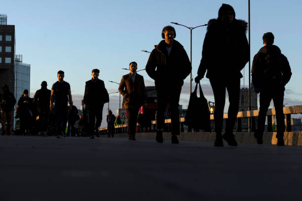Commuters walk over London Bridge towards the City of London on January 31, 2022 in London, England. Last week, Transport for London reported a...