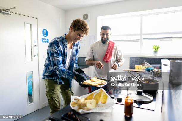 making garlic bread! - share house stock pictures, royalty-free photos & images