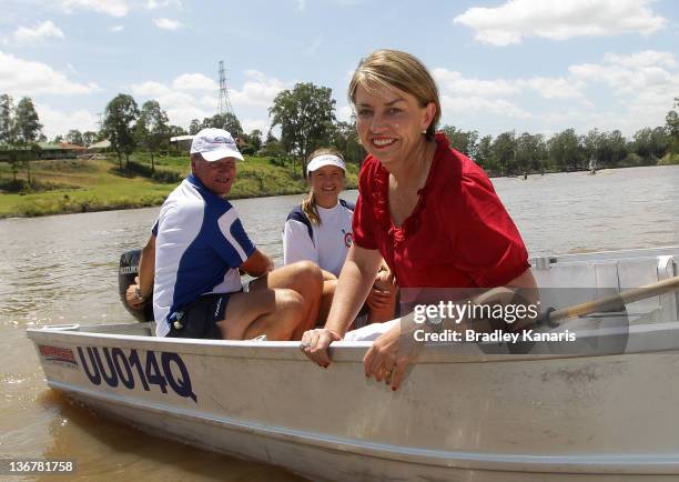 Queensland Premier Anna Bligh poses for a photo on a boat on the Brisbane River after visiting members of the Centenary Rowing Club which was hard...