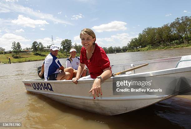 Queensland Premier Anna Bligh poses for a photo on a boat on the Brisbane River after visiting members of the Centenary Rowing Club which was hard...