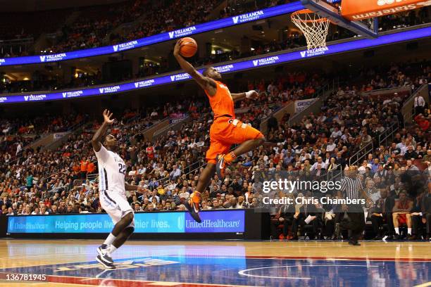 Dion Waiters of the Syracuse Orange dunks in the second half against JayVaughn Pinkston of the Villanova Wildcats at the Wells Fargo Center on...