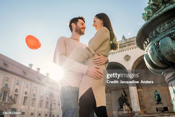 a happy couple in love is having a fun time in the city - love is /// stock-fotos und bilder