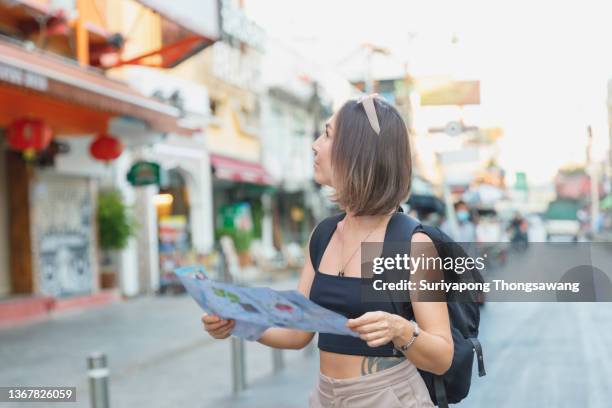 young tourist women exploring in the city of southeast asia by using map for navigate to destination. - khao san road stock pictures, royalty-free photos & images