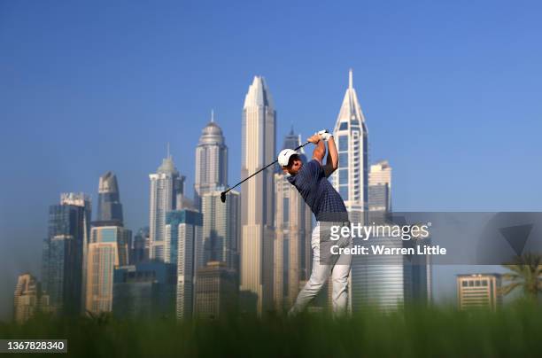 Rory McIlroy of Northern Ireland plays his approach shot on the 13th hole during day one of the Slync.io Dubai Desert Classic at Emirates Golf Club...