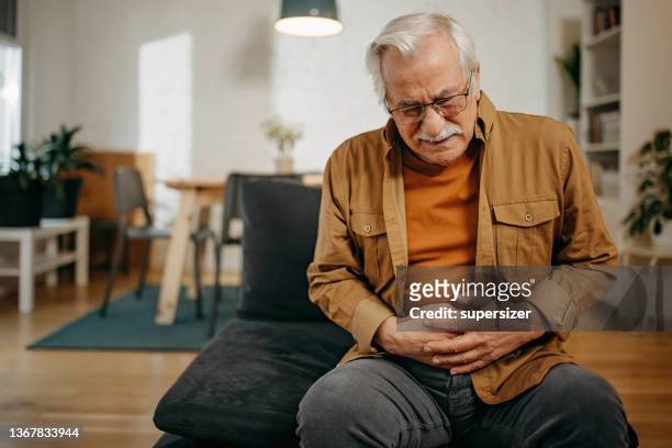 senior man has stomachache - human intestine stockfoto's en -beelden