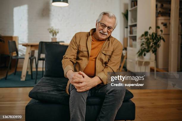 older man has knee pain - male knee stock pictures, royalty-free photos & images