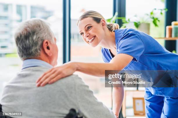 shot of a young female doctor comforting a senior patient at a clinic - patient visit stock pictures, royalty-free photos & images