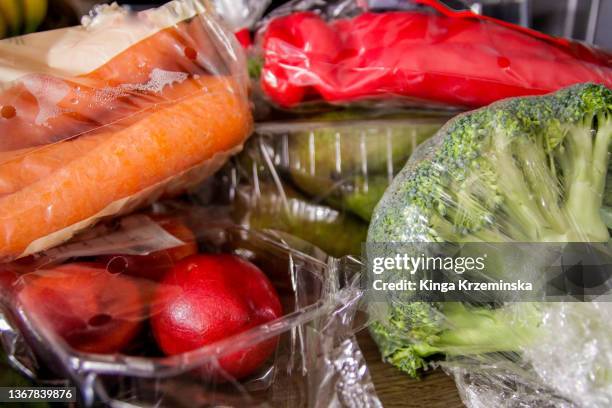 fruit and vegetables in plastic bags - avvolto foto e immagini stock