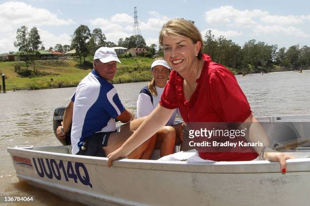 Queensland Premier Anna Bligh poses for a photo on a boat on the Brisbane River after visiting members of the Centenary Rowing Club which was hard...