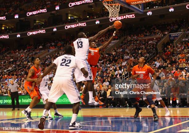 Dion Waiters of the Syracuse Orange drives for a shot attempt in the second half against Mouphtaou Yarou of the Villanova Wildcats at the Wells Fargo...