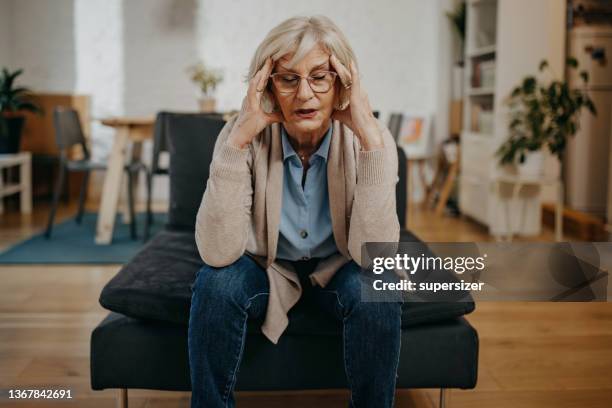 older woman having headache - dizzy stock pictures, royalty-free photos & images