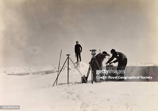 Members of the expedition with surveying equipment during the Shackleton-Rowett Antarctic Expedition 1921-1922 'Quest'.