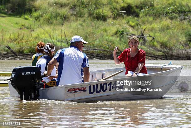 Queensland Premier Anna Bligh rides on a boat on the Brisbane River after visiting members of the Centenary Rowing Club which was hard hit by the...