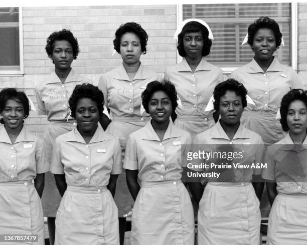 Group of nine nursing students posing outside the Veteran's Administration Hospital in Houston, TX, 1960s.