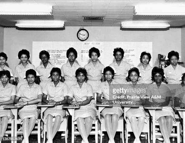 Group of nursing students in their uniforms in a classroom at Prairie View A&M University, Prairie View, TX, 1960s.