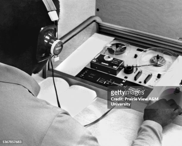 Male student working with audio equipment at Prairie View A&M University, Prairie View, TX, 1970s.