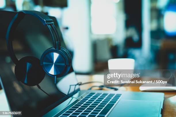 headphones on laptop with coffee cup and mouses in blur background,thailand - mouses computer stock pictures, royalty-free photos & images