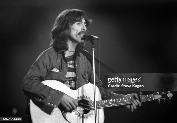 English Pop and Rock musician George Harrison plays guitar as he performs onstage at Olympia Stadium, Detroit, Michigan, December 4, 1974.