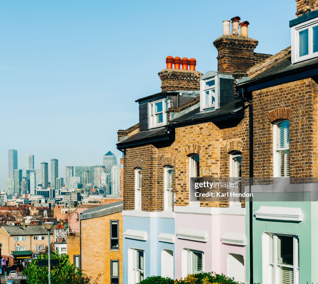 Colourful London townhouses in Greenwich, London with Canary Wharf in the background