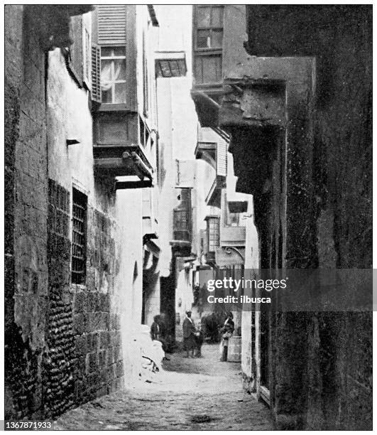 antique travel photographs of egypt: old street, cairo - alley stock illustrations