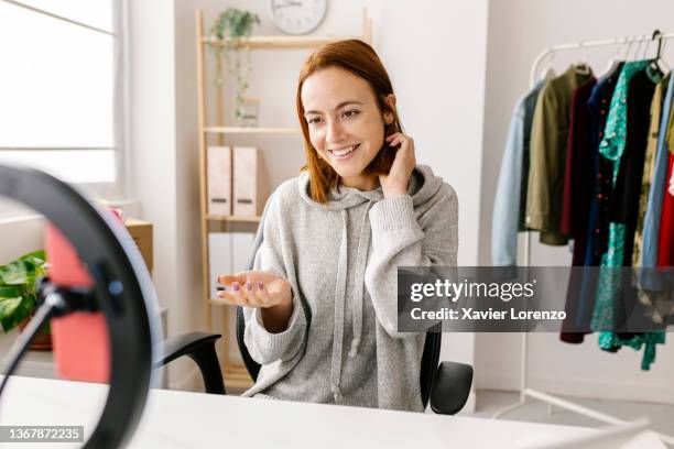 young influencer vlogging about new trends in workshop store - tutorial stockfoto's en -beelden