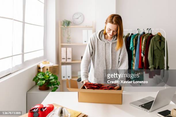 small business female owner preparing new orders for online customers - internet of things imagens e fotografias de stock