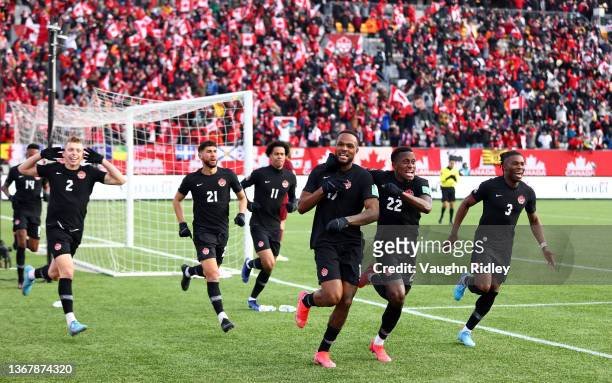 Cyle Larin of Canada celebrates his goal with Richie Laryea and teammates during a 2022 World Cup Qualifying match against the United States at Tim...