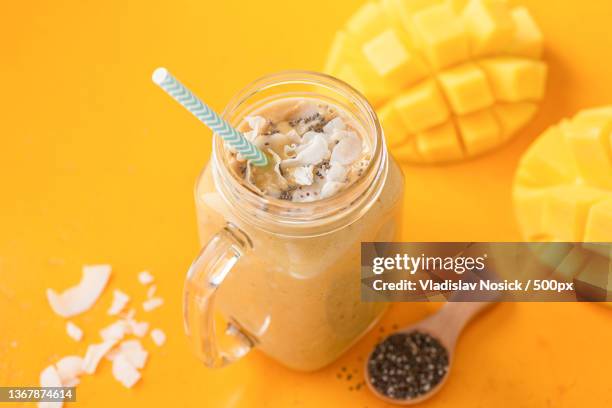 mango coconut smoothie,high angle view of drink in jar on table,russia - lassi stock-fotos und bilder