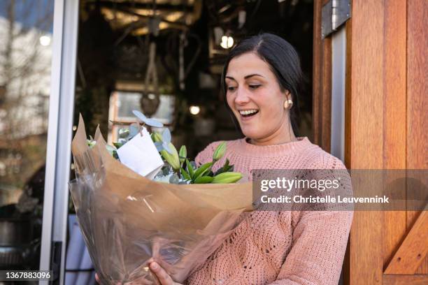 happy client receiving a flower bouquet - flower delivery stock pictures, royalty-free photos & images