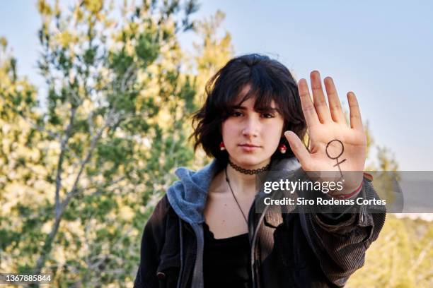 woman showing female symbol - feminism stock pictures, royalty-free photos & images