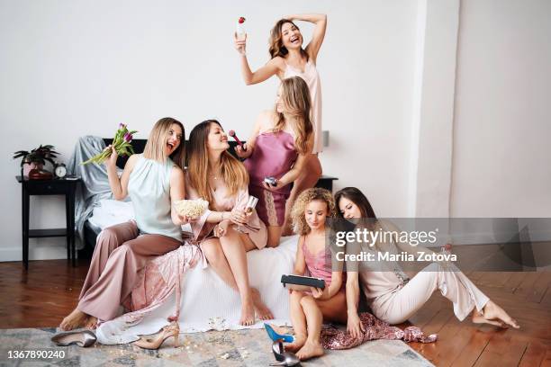 women's pajama flower party at home. girls have fun, watch movies, eat popcorn. international women's day - roupa de dormir - fotografias e filmes do acervo