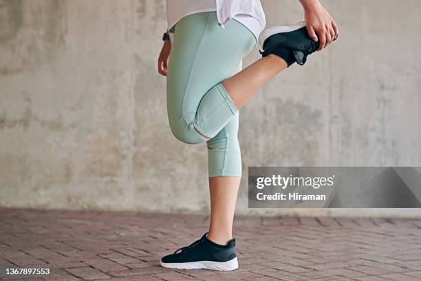 closeup shot of a sporty woman stretching her legs while exercising outdoors - woman standing on one leg stock pictures, royalty-free photos & images