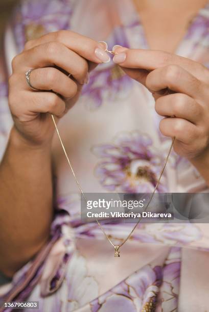 woman holding necklace. - pendant stock pictures, royalty-free photos & images