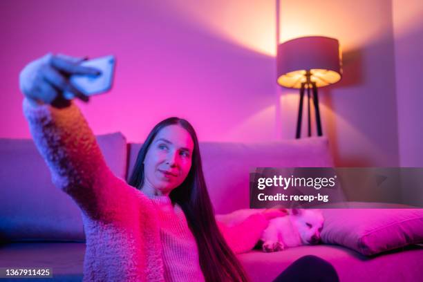 beautiful woman taking selfies with smart phone with her dog - pampered pets stock pictures, royalty-free photos & images