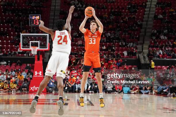 Coleman Hawkins of the Illinois Fighting Illini takes a shot over Donta Scott of the Maryland Terrapins during a college basketball game at the...