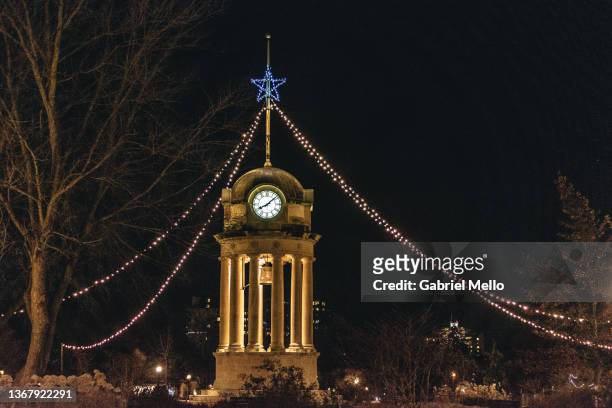 night shot of clock tower at victoria park in kitchener ontario - kitchener canada stock pictures, royalty-free photos & images