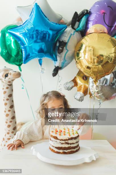 young girl blowing candles for celebreating her 2th years birthday. - 2 3 years stock pictures, royalty-free photos & images