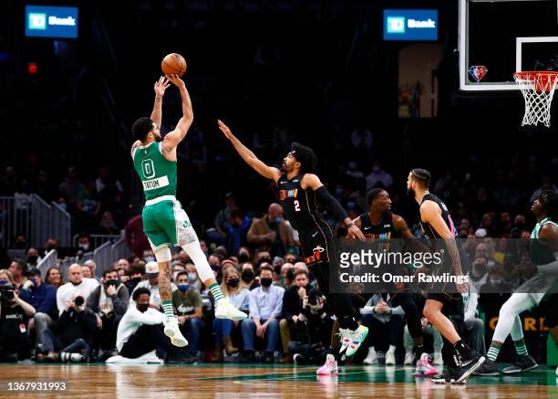 Jayson Tatum of the Boston Celtics shoots a jump shot over Gabe Vincent of the Miami Heat during the first quarter of the game at TD Garden on...