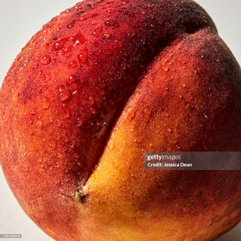 Close-up of a peach on white background.