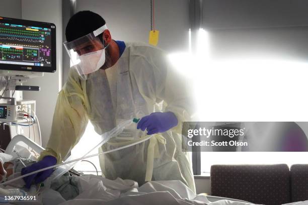 Respiratory Therapist Adel Al Joaid treats a COVID-19 patient in the ICU at Rush University Medial Center on January 31, 2022 in Chicago, Illinois....